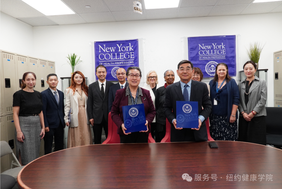 NYCHP President Dr. A Li Song and delegation representatives holding memorandum-of-understanding folders after the signing